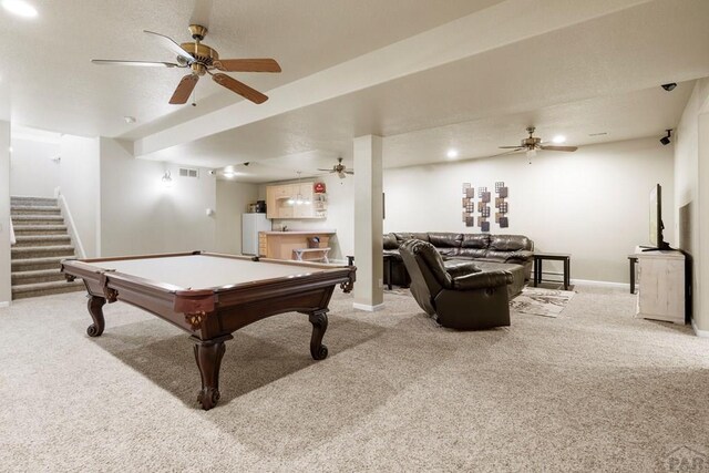 rec room featuring baseboards, visible vents, light colored carpet, ceiling fan, and bar area