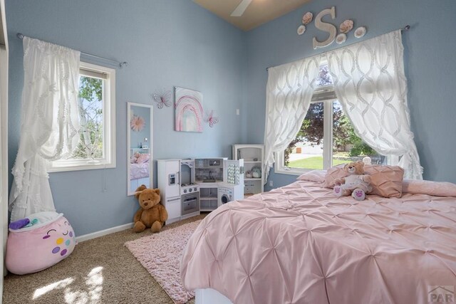 carpeted bedroom featuring baseboards