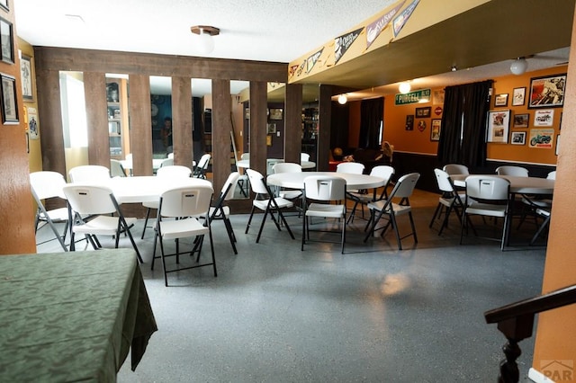 dining area with speckled floor and a textured ceiling