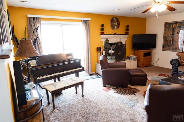 living area with carpet floors and ceiling fan