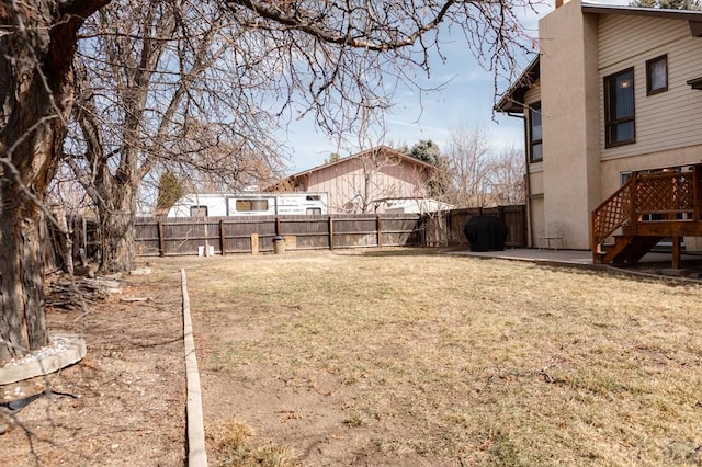 view of yard with stairs, a patio, and a fenced backyard