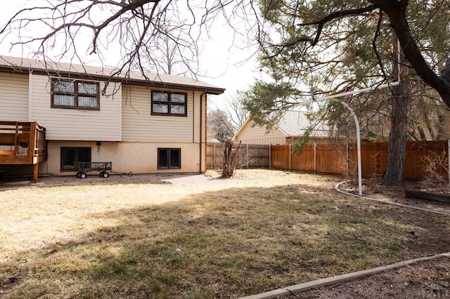 back of property featuring a yard and a fenced backyard