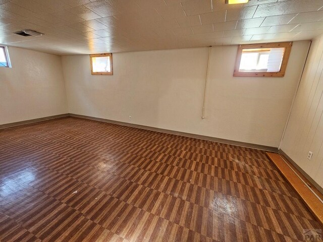 below grade area with plenty of natural light, visible vents, and baseboards