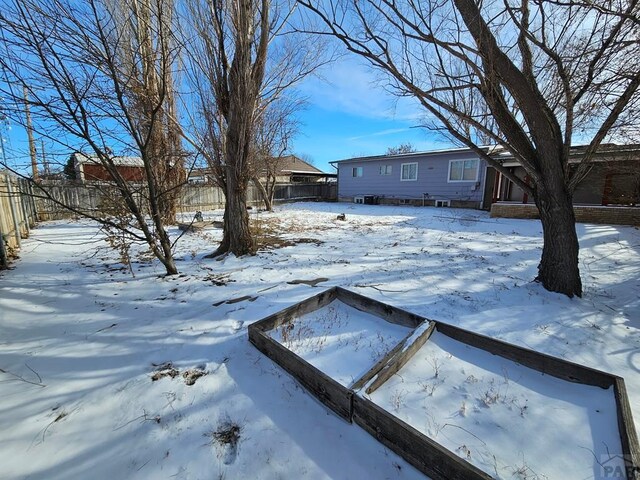 yard covered in snow with fence