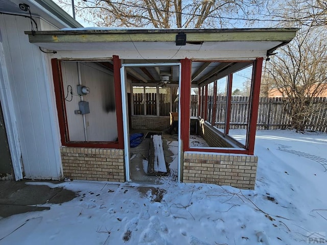 exterior space with brick siding and fence