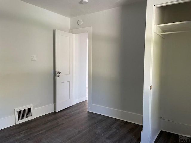 1540 E 13th St, Pueblo, CO 81001 - unfurnished bedroom featuring dark wood-style flooring and baseboards
