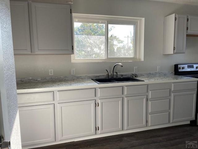 1540 E 13th St, Pueblo, CO 81001 - kitchen with a sink, stainless steel range with electric cooktop, light stone counters, and dark wood-type flooring