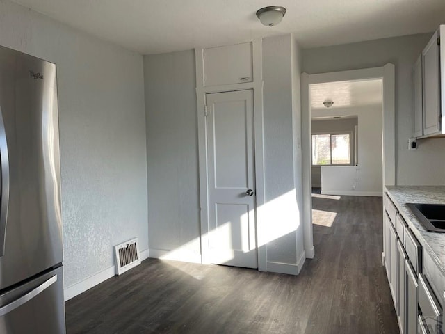 1540 E 13th St, Pueblo, CO 81001 - kitchen featuring freestanding refrigerator, dark wood finished floors, and baseboards
