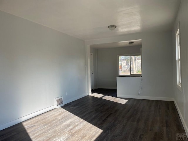 1540 E 13th St, Pueblo, CO 81001 - spare room with dark wood-style floors and baseboards