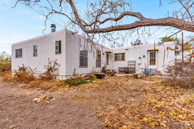 back of property with stucco siding