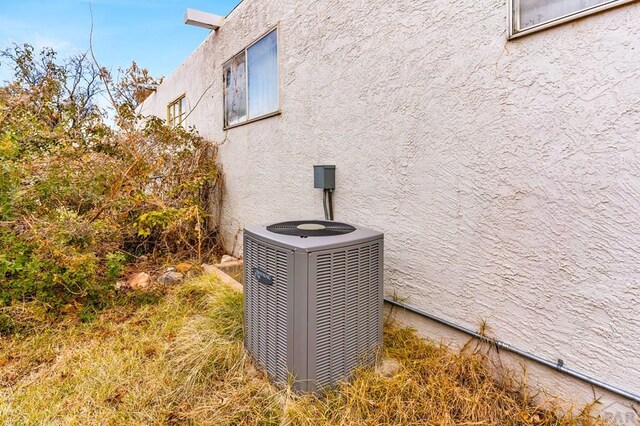 details with cooling unit and stucco siding