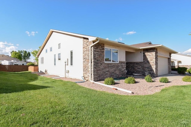 view of side of property with stone siding, an attached garage, and stucco siding