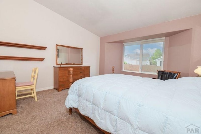 bedroom featuring lofted ceiling, carpet, and baseboards