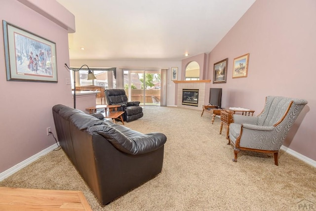living room featuring carpet flooring, baseboards, and a tile fireplace