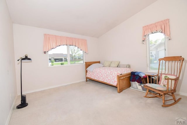 bedroom featuring carpet flooring, multiple windows, baseboards, and vaulted ceiling