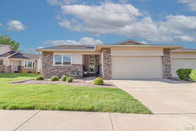 view of front of home with stone siding, an attached garage, a front yard, and driveway
