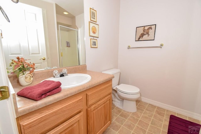 full bathroom with a shower stall, toilet, vanity, and baseboards