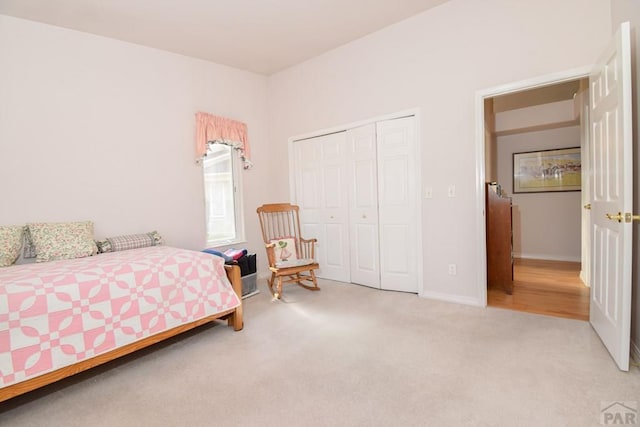 bedroom featuring carpet, a closet, and baseboards
