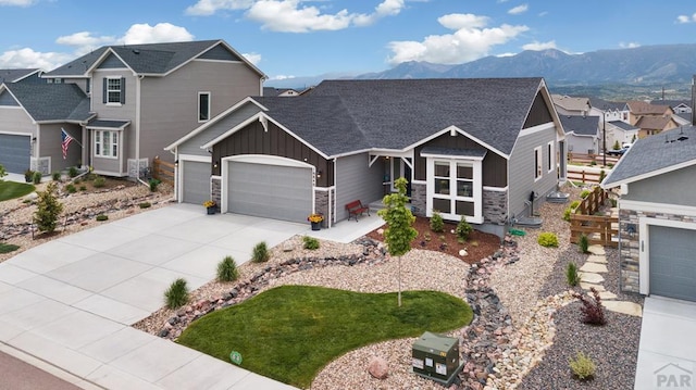 16840 New Autum Dr, Monument, CO 80132 - craftsman-style home with board and batten siding, a garage, stone siding, and concrete driveway