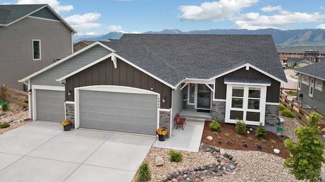 16840 New Autum Dr, Monument, CO 80132 - craftsman-style home featuring board and batten siding, a garage, stone siding, a mountain view, and concrete driveway