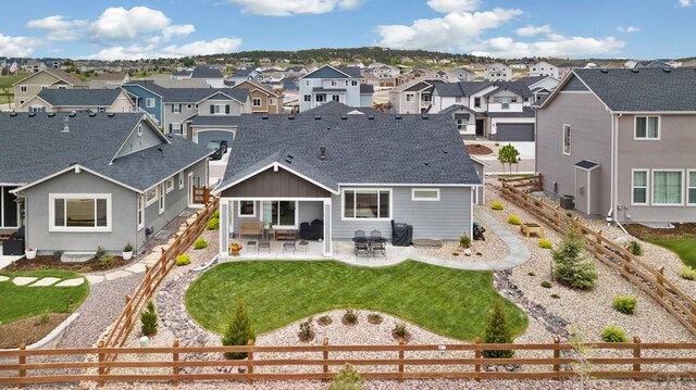 16840 New Autum Dr, Monument, CO 80132 - back of property with a residential view, roof with shingles, and a patio area