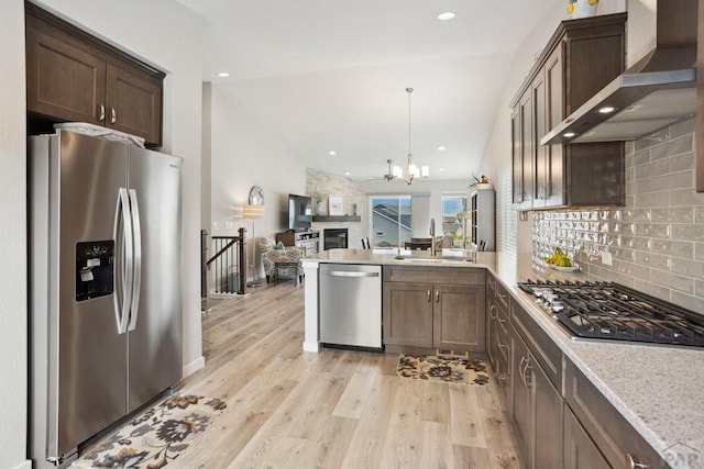 16840 New Autum Dr, Monument, CO 80132 - kitchen with appliances with stainless steel finishes, wall chimney exhaust hood, a sink, backsplash, and lofted ceiling