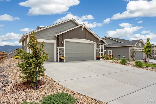 16840 New Autum Dr, Monument, CO 80132 - view of front facade with a garage, board and batten siding, concrete driveway, and stone siding