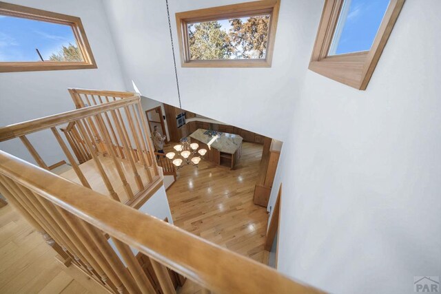 unfurnished living room featuring baseboards, visible vents, a tile fireplace, wood finished floors, and vaulted ceiling