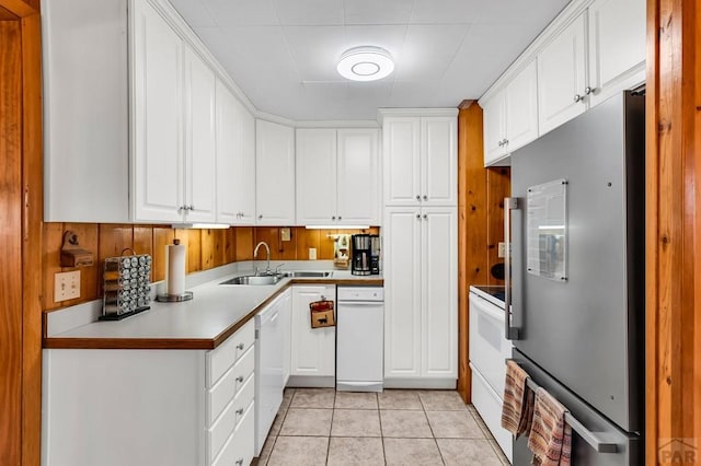 kitchen featuring dishwasher, high quality fridge, white cabinets, and light countertops