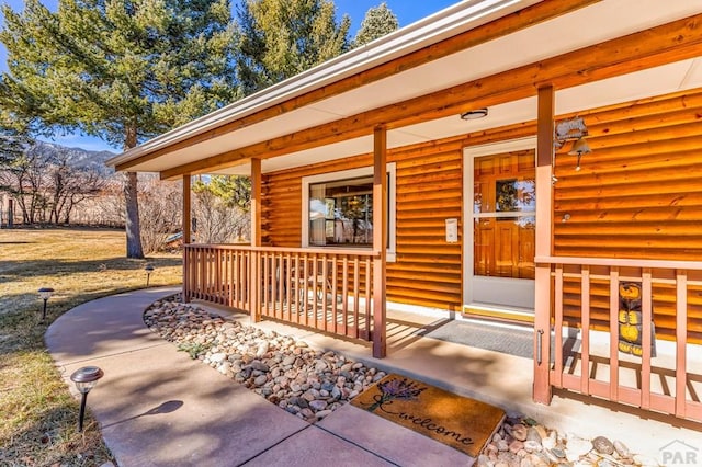 view of exterior entry with a porch