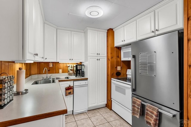 kitchen with white cabinets, refrigerator, white electric range, a sink, and light tile patterned flooring