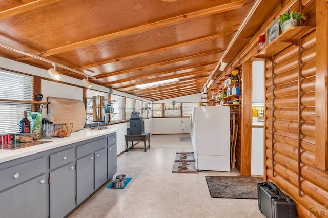 kitchen with light countertops, a wealth of natural light, gray cabinets, and freestanding refrigerator