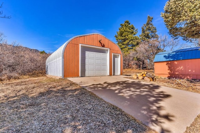 detached garage with concrete driveway