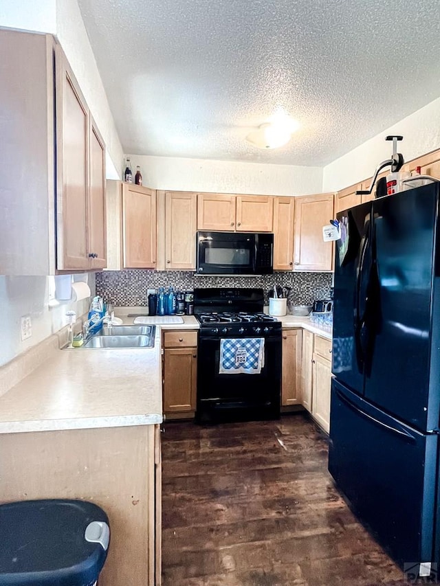 1320 Bradish Ave, La Junta, CO 81050 - kitchen with black appliances, a sink, dark wood-type flooring, light brown cabinetry, and light countertops