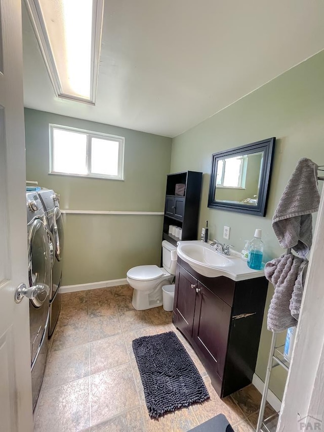 1320 Bradish Ave, La Junta, CO 81050 - bathroom with washing machine and dryer, plenty of natural light, toilet, and vanity