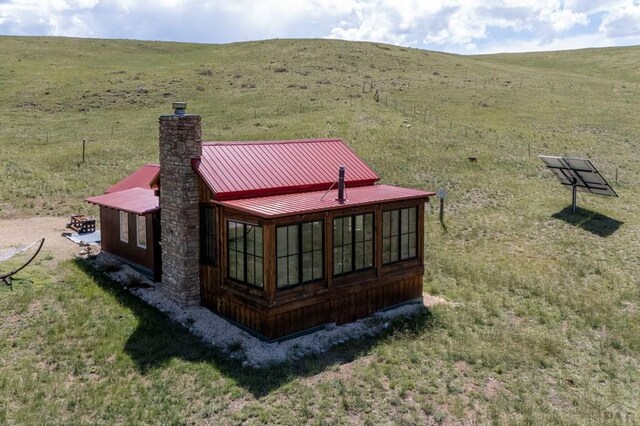 1225 Brokenhand Rd, Westcliffe, CO 81252 - rear view of house with a chimney and a metal roof