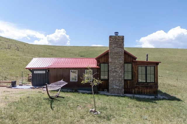 1225 Brokenhand Rd, Westcliffe, CO 81252 - back of property with a yard and a chimney