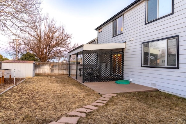 view of yard with a patio area, an outdoor structure, and fence