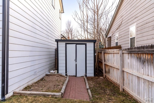 view of shed featuring a vegetable garden and a fenced backyard