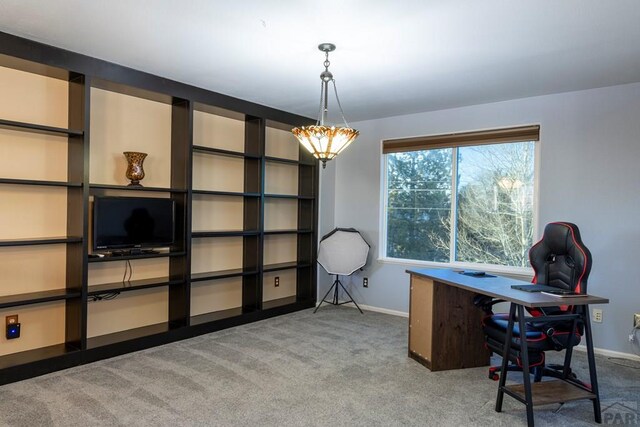 carpeted office featuring baseboards and a chandelier