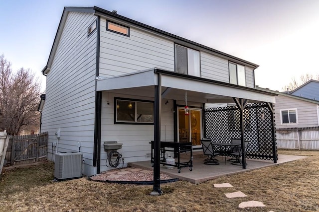 back of property featuring cooling unit, fence, and a patio area