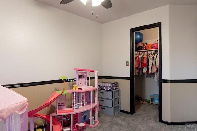 game room with carpet flooring and ceiling fan