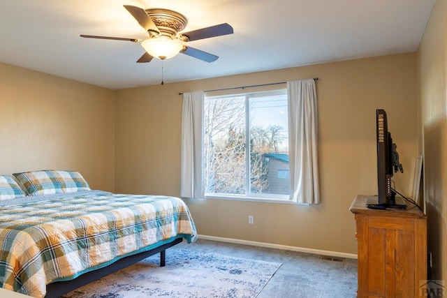 bedroom with multiple windows, baseboards, and carpet