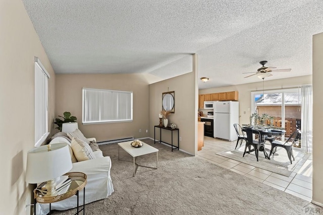 living area with a baseboard radiator, lofted ceiling, light colored carpet, a ceiling fan, and light tile patterned flooring