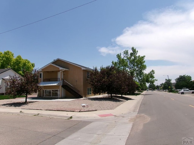 2110 Northmoor Ter Unit 2, Pueblo, CO 81001 - view of asphalt street featuring stairway, sidewalks, curbs, and street lighting