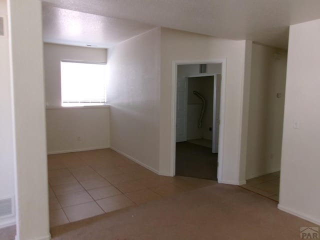 2110 Northmoor Ter Unit 2, Pueblo, CO 81001 - empty room featuring tile patterned flooring and a textured ceiling