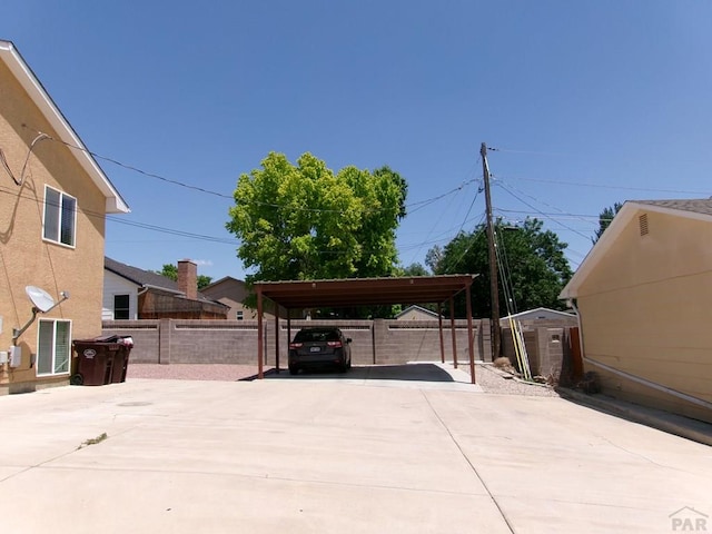 2110 Northmoor Ter Unit 2, Pueblo, CO 81001 - view of patio featuring a detached carport, driveway, and a storage shed
