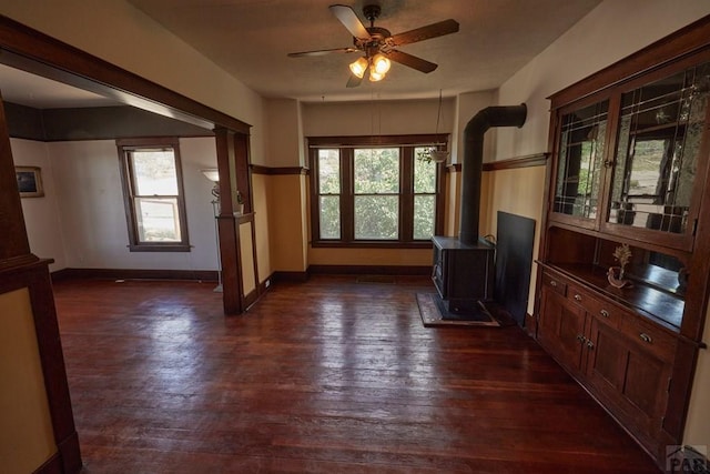 315 S Oak St, Trinidad, CO 81082 - interior space with a wood stove, plenty of natural light, a ceiling fan, and dark wood finished floors