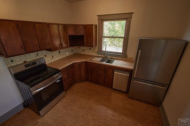 315 S Oak St, Trinidad, CO 81082 - kitchen with appliances with stainless steel finishes, a sink, light countertops, and backsplash