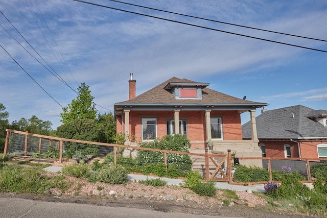 315 S Oak St, Trinidad, CO 81082 - view of front of property with covered porch, brick siding, a chimney, and a fenced front yard